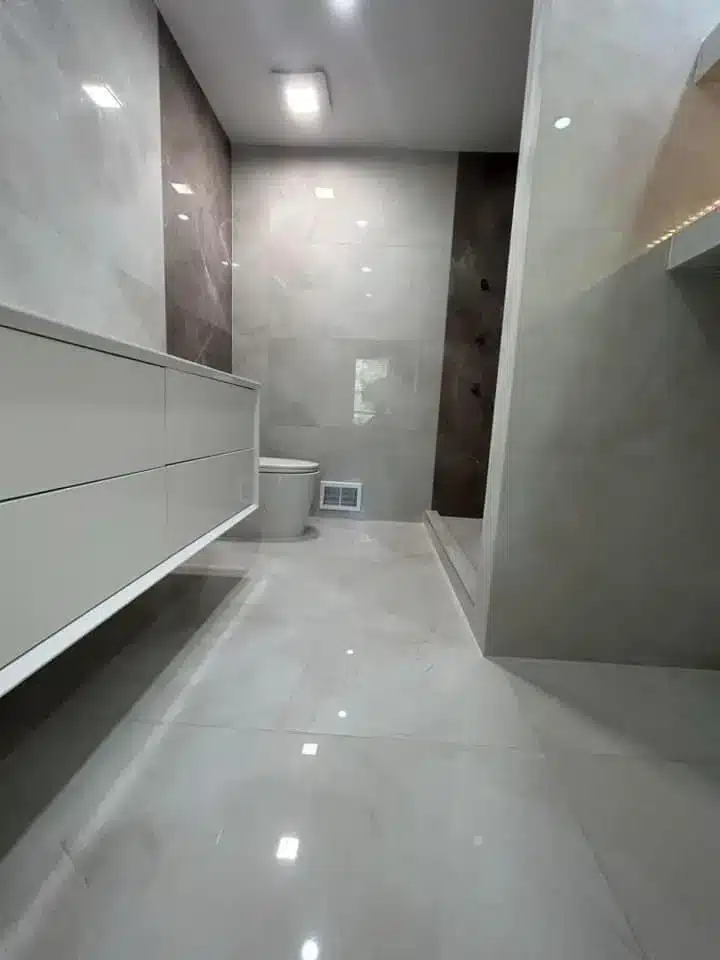 Luxuriöses Badezimmer mit glänzenden Fliesen München Modernes Badezimmer mit glänzenden Fliesen und Duschbereich in München