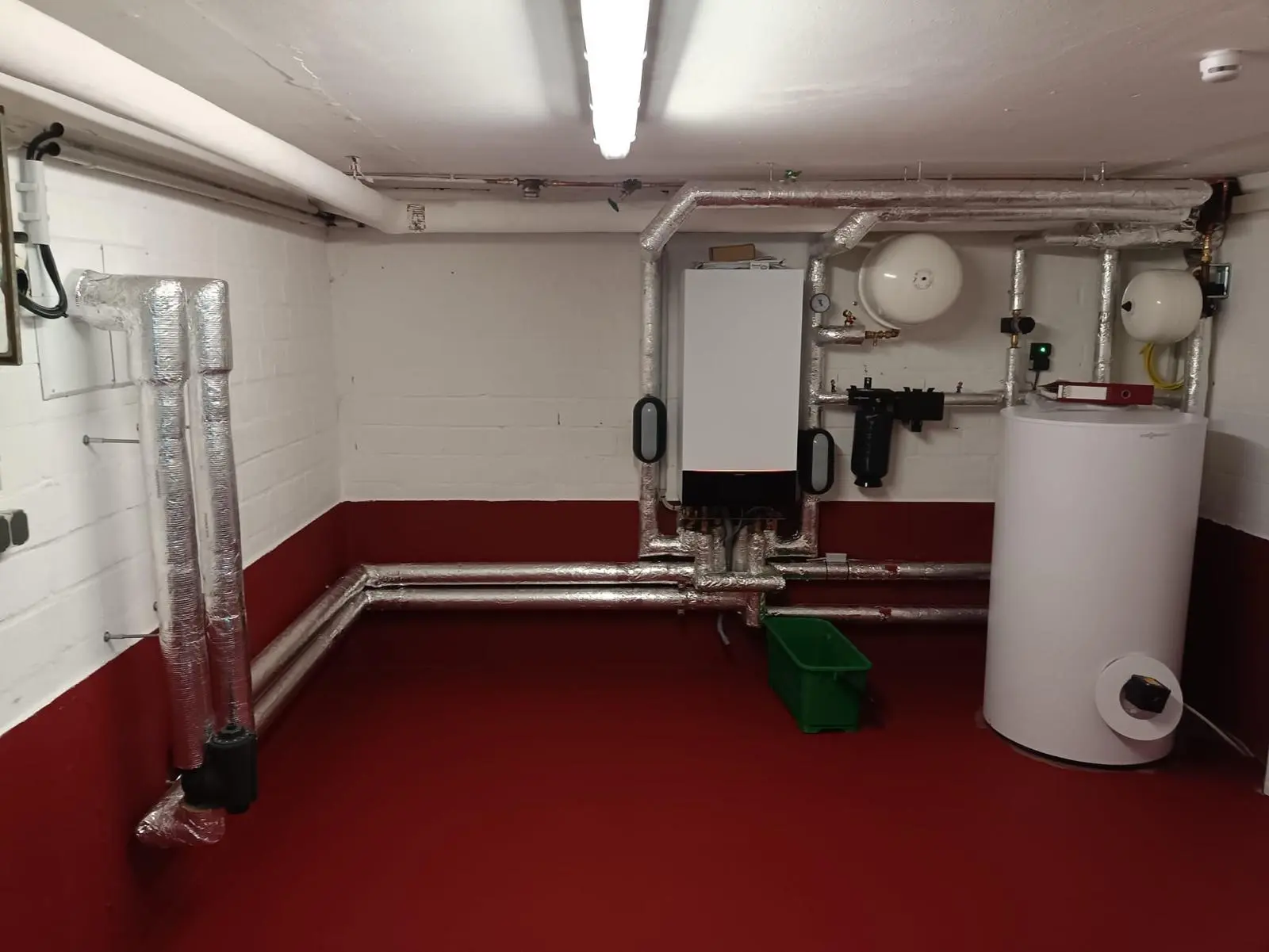 Moderne Heizungsinstallation München Moderne Heizungsanlage mit Rohrisolierung in einem Technikraum in München